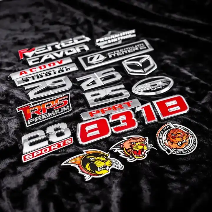 Collection of completed custom chrome badges including sports numbers, logos, and mascot emblems
